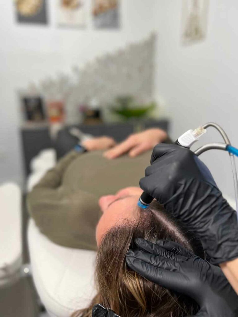 Woman Having Hair Restoration Treatment by Laying on Medical Cot | Aspen Prime MedSpa in Hoboken, NJ
