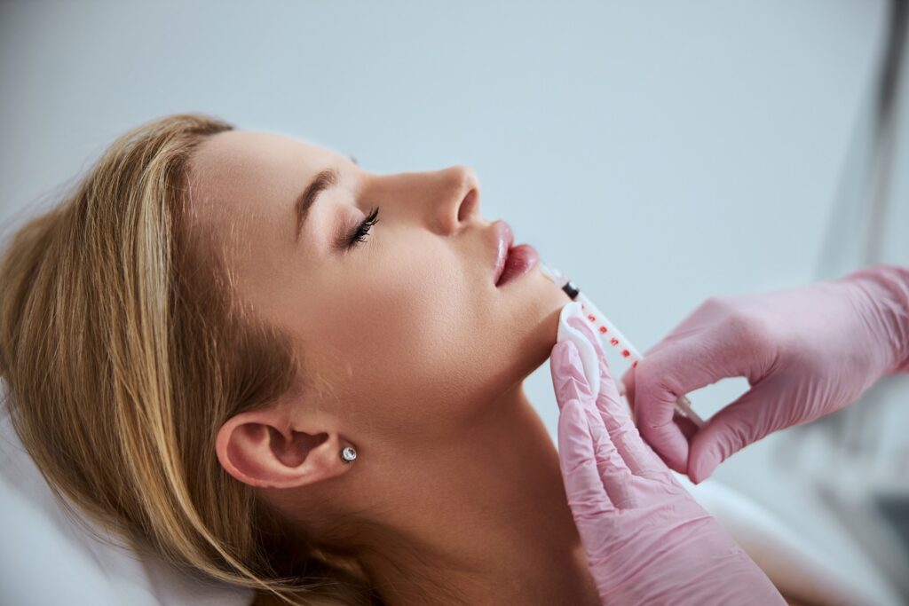 Professional cosmetologist injecting a dermal filler into the patient lips at Aspen Prime Med Spa in Hoboken, NJ
